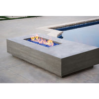 Tavola V Gas Fire Table by Prism Hardscapes in concrete with linear design and lava rock burning display