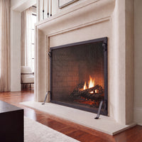 Hammered Edge fireplace screen in an elegant limestone fireplace setting