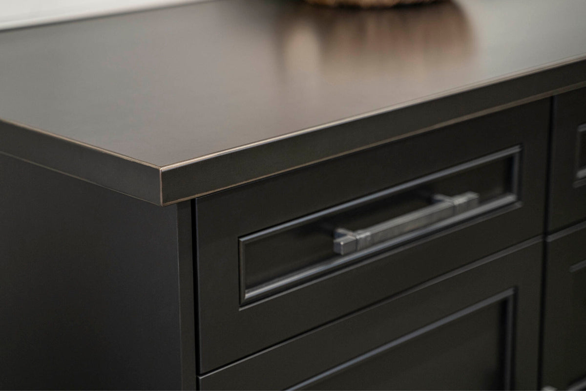 Close-up of a countertop edge and cabinetry from Stoll Industries
