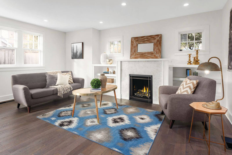 Napoleon Altitude X 36 gas fireplace lifestyle shot with driftwood logs and flames