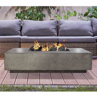 38-inch rectangular concrete Tavola IV gas fire pit table by Prism Hardscapes with lava rock burning display