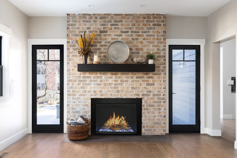Modern Flames Orion Traditional firebox with surround trim installed in a brick fireplace opening