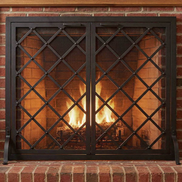 Custom free standing fireplace screen with thick solid steel frame and heavy gauge mesh in textured black