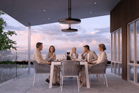 Bromic Eclipse Electric pendant heaters with twin-pole mounts above a covered terrace dining table. Manufacturer installation inspiration; accessories shown sold separately.