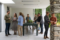 Bromic Platinum Electric heaters recessed into a white patio ceiling above an outdoor dining area. Manufacturer installation inspiration; accessories shown sold separately.