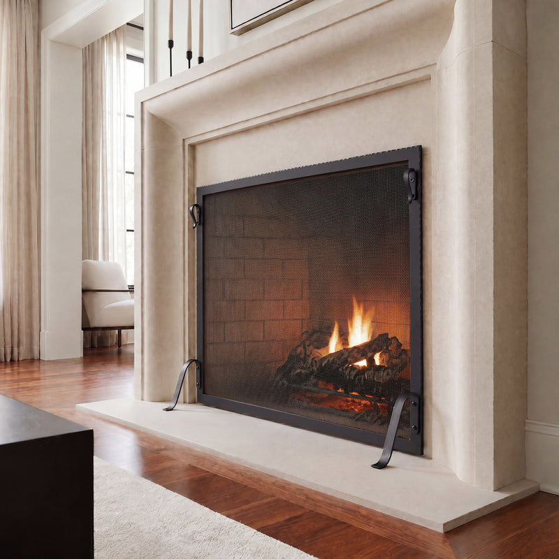Hammered Edge fireplace screen in matte black at a limestone fireplace