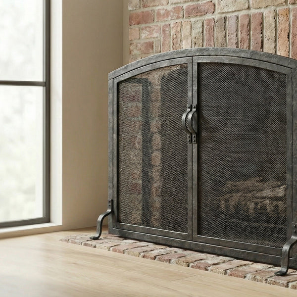 Custom free standing fireplace screen with forged doors and heavy gauge mesh