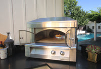 Countertop oven with glass doors open, showing the ceramic cooking hearth