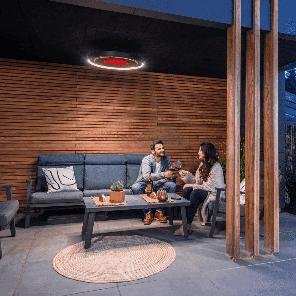 An Eclipse heater lights an evening together on a timber-lined patio