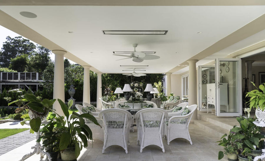 Platinum electric heaters recessed into the ceiling of a white garden terrace