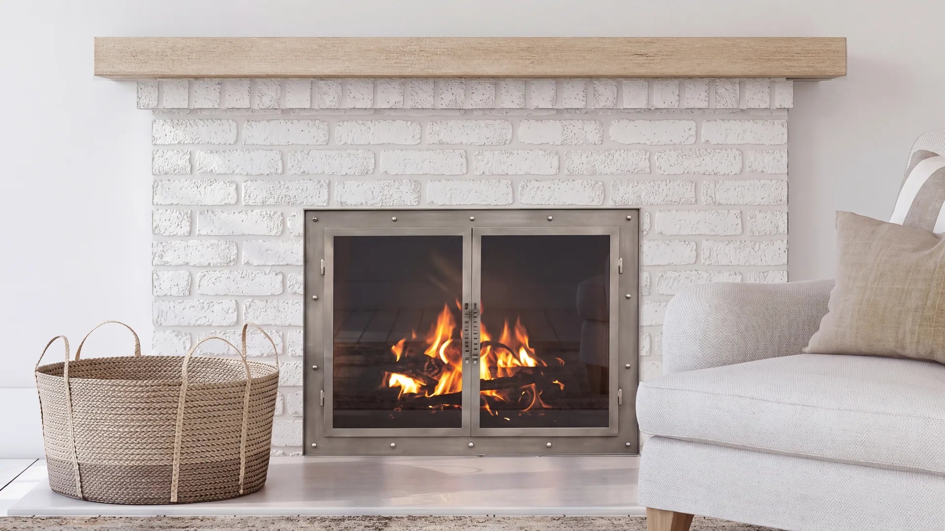 A Flat Sawn Pale Honey concrete mantel shelf above a white painted brick fireplace with stainless steel glass doors and a lit fire